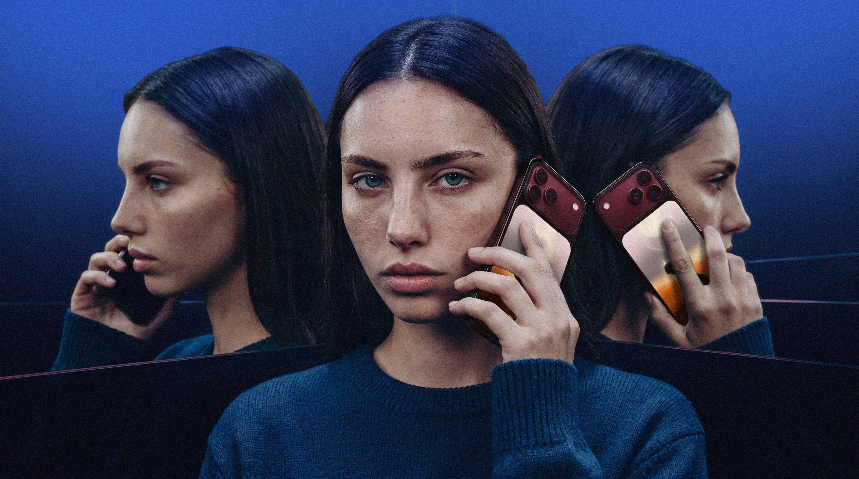 A woman holds a phone beside her face, reflected in mirrors against a deep blue background.